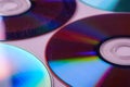 CD DVD compact disc disk dispersion refraction reflection of light colors texture on pink background close up Royalty Free Stock Photo