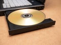 CD DVD optical disc media inserted in a laptop computer disc tray, closeup, nobody. Films, movies software data storage Royalty Free Stock Photo