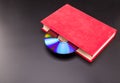 Cd is sticks out from red book Royalty Free Stock Photo