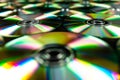 CDs / DVDs lying on a black background with colorful reflections of light. Royalty Free Stock Photo