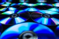 CDs / DVDs lying on a black background with reflections of light.