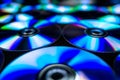 CDs / DVDs lying on a black background with reflections of light.