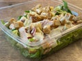 A ceaser salade in a plastic bowl Royalty Free Stock Photo