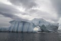 Ceberg with arch and gullies on a cloudy autumn Royalty Free Stock Photo