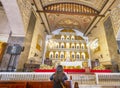 A devout Filipino worshiper,kneels before the intricate golden altar of the Basilica of Saint Nino,Cebu\'s oldest church