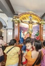 Filipino visitors, at the Basilica of Saint Nino,queue to pray at the feet of Jesus