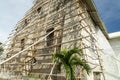 Filipino workmen on bamboo scaffolding,redecorating the end wall of Oslob Church,high above the ground,Cebu,Philippines Royalty Free Stock Photo