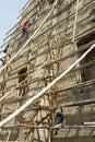 Filipino workmen on bamboo scaffolding,redecorating the end wall of Oslob Church,high above the ground,Cebu,Philippines Royalty Free Stock Photo