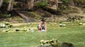 Cebu, Philippines - 6 June, 2017: The poor woman washing clothes in river.