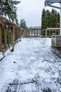 Cedar deck after snow shoveled off, stormy snow day