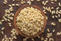 Cedar nuts peeled in wooden bowl, top view Royalty Free Stock Photo