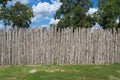 Cedar picket fence trees clouds Royalty Free Stock Photo