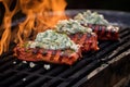 cedar plank on grill with melted blue cheese and sauce