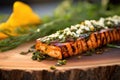 cedar plank with grilled feta cheese and herbs close-up Royalty Free Stock Photo