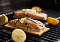 Cedar plank salmon with lemon and rosemary on grill Royalty Free Stock Photo