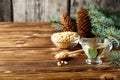 Cedar products: cedar oil, nuts, cones, brunches on a wooden broun background