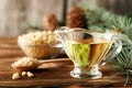 Cedar products: cedar oil, nuts, cones, brunches on a wooden broun background Royalty Free Stock Photo