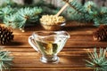 Cedar products: cedar oil, pine nuts, cones, brunches on a wooden broun background Royalty Free Stock Photo