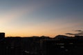 Cedritos neighborhood dusk scene with blue orange sky and andean mountains silhouette at background Royalty Free Stock Photo