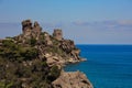 Cefalu Castle or Rocca della Cefalu, near Palermo in Sicily. Ancient ruins on a headland with deep blue sea and sky background Royalty Free Stock Photo