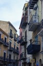 Traditional Sicilian street with old residential house. Underwear drying on the balcony fence Royalty Free Stock Photo