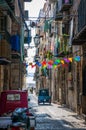 Cefalu old town narrow street view with cars parked and small balconies at the morning Royalty Free Stock Photo