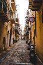 People walking in the street of Cefalu city in Sicily.