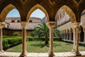 Cefalu,Sicily-June 6, 2021.Roman Catholic cathedral with cloister,arcade has pointed arches and columns.Monastery courtyard garden