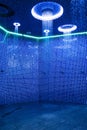 Ceiling in a blue shower room with dynamic LED lighting vertical