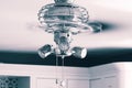 Ceiling fan light fitting with blades spinning in a kitchen. Royalty Free Stock Photo