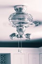 Ceiling fan light fitting with blades spinning in a kitchen. Royalty Free Stock Photo