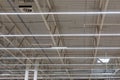 Ceiling of industrial building with LED lamps and ventilation window in shopping center or warehouse