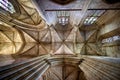 The ceiling in the interior of a historic cathedral with arches and stained glass window Royalty Free Stock Photo