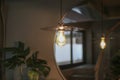 Ceiling lamp warm orange tone light color bulb reflection on mirror in coffee shop. Royalty Free Stock Photo