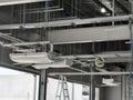 The ceiling of a large building under construction an extensive network of pipes Royalty Free Stock Photo