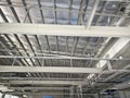 The ceiling of a large building under construction an extensive network of pipes Royalty Free Stock Photo