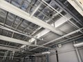 The ceiling of a large building under construction an extensive network of pipes Royalty Free Stock Photo