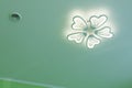 Ceiling with LED chandelier and air vent. Decorative LED chandelier in the form of a flower under the ceiling. Royalty Free Stock Photo