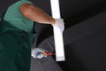 Ceiling light. Electrician installing led linear lamp indoors, bottom view Royalty Free Stock Photo