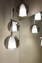 Ceiling light. Modern three-lamp chandelier. Lamp in the bathroom. Reflected in the mirror