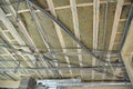 Ceiling mineral wool insulation with ventilation pipes and electricity wiring, power cables in pvc conduit installed on the Royalty Free Stock Photo