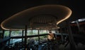 A ceiling of a modern hotel with amber light