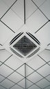 Ceiling mounted air conditioning unit embedded in white tiles, indoor office space Royalty Free Stock Photo