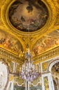 Ceiling painting and chandelier hanging in the corridor of the Hall of Mirrors