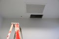 Ceiling panels hole in roof office from drain pipes leakage with step ladder