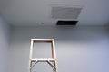 Ceiling panels hole in roof office from drain pipes leakage with step ladder