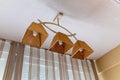 Ceiling sand lamp from white ceiling and beige courtains