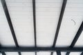 The ceiling of the street terrace is made of white wooden lining and black cross beams. Conducted wire in a corrugated pipe for Royalty Free Stock Photo