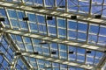 Ceiling structure made of metal and glass. Blue sky view Royalty Free Stock Photo