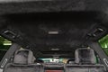 The ceiling of the SUV car pulled by black soft material alkantara in the workshop for tuning and styling the interiorof the